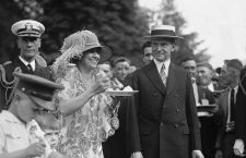 President Calvin Coolidge (1872-33) smiles along with his wife at a White House garden party in June 1926.