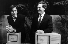 Apple Computer Chairman Steven P Jobs (left) and Apple President John Sculley prior to a shareholders ' meeting here in Cupertino , California . Jobs is standing behind a new Macintosh personal computer ; Sculley is with the Lisa II personal computer the company produces .
24 January 1984