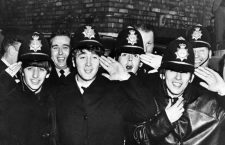 The Beatles dressed in policemens helmets as an emergency disguise to escape fans in Birmingham . 11th November 1963
