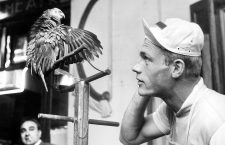 German cyclist Rudi Altig listens to a parrot on the 6th of July in 1962 at the destination of the Tour de France stage in Bayonne. | usage worldwide